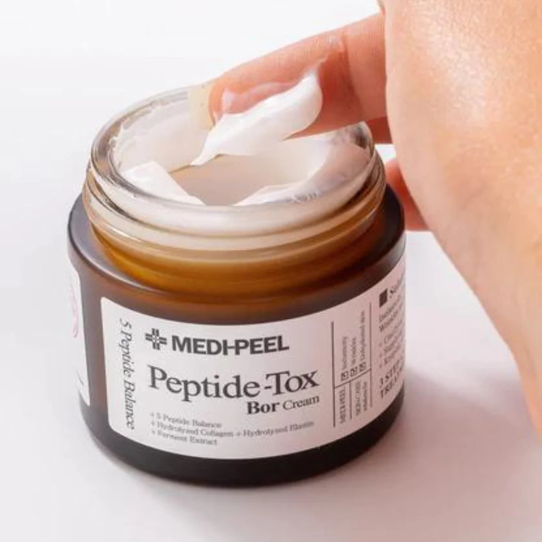 MEDI-PEEL Peptide-Tox Bar Cream jar with a hand applying cream on a white background
