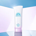 Anessa sunscreen gel bottle on a gradient blue and pink background