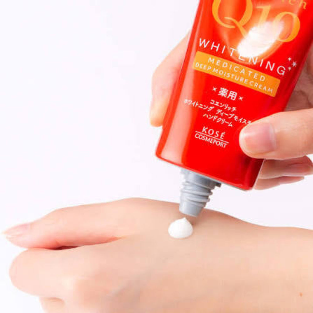 Kose cosmetic cream being applied to a hand with a white background